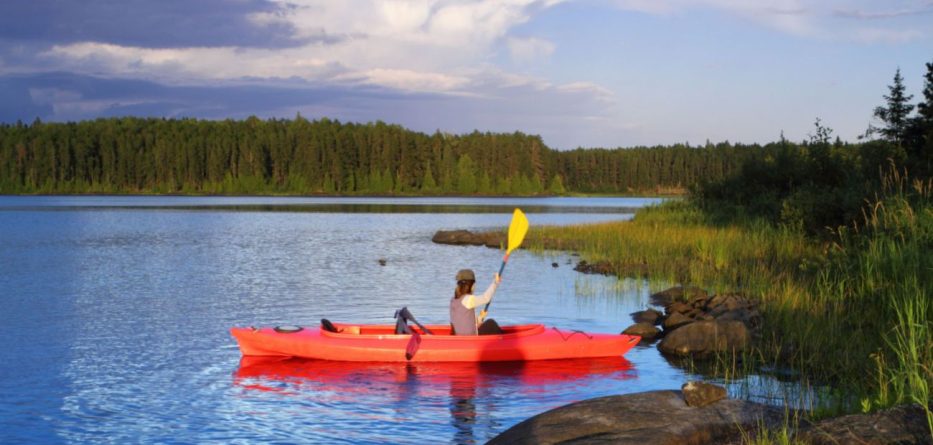 Woman Kayaking On A Lake